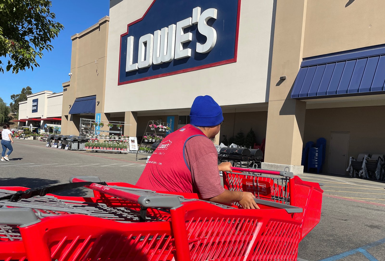 A shopping cart sits in front of a Lowe's store on November 21, 2023 in Pacoima, California.