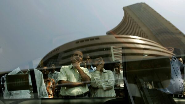 Indian stock market: Onlookers watch share prices on a screen on the facade of the Bombay Stock Exchange, reflected in a car window, in Mumbai, India, Friday, March 7, 2008. (Photo: AP)