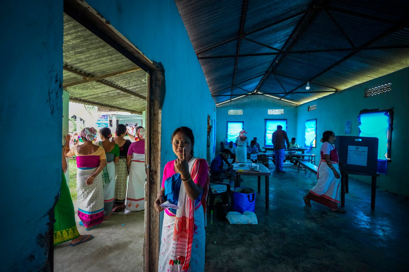 A Deori tribal woman shows the indelible ink mark on her finger after casting her vote during the first round of polling of India's national election in Jorhat, India, Friday, April 19, 2024. Nearly 970 million voters will elect 543 members for the lower house of Parliament for five years, during staggered elections that will run until June 1. (AP Photo/Anupam Nath)