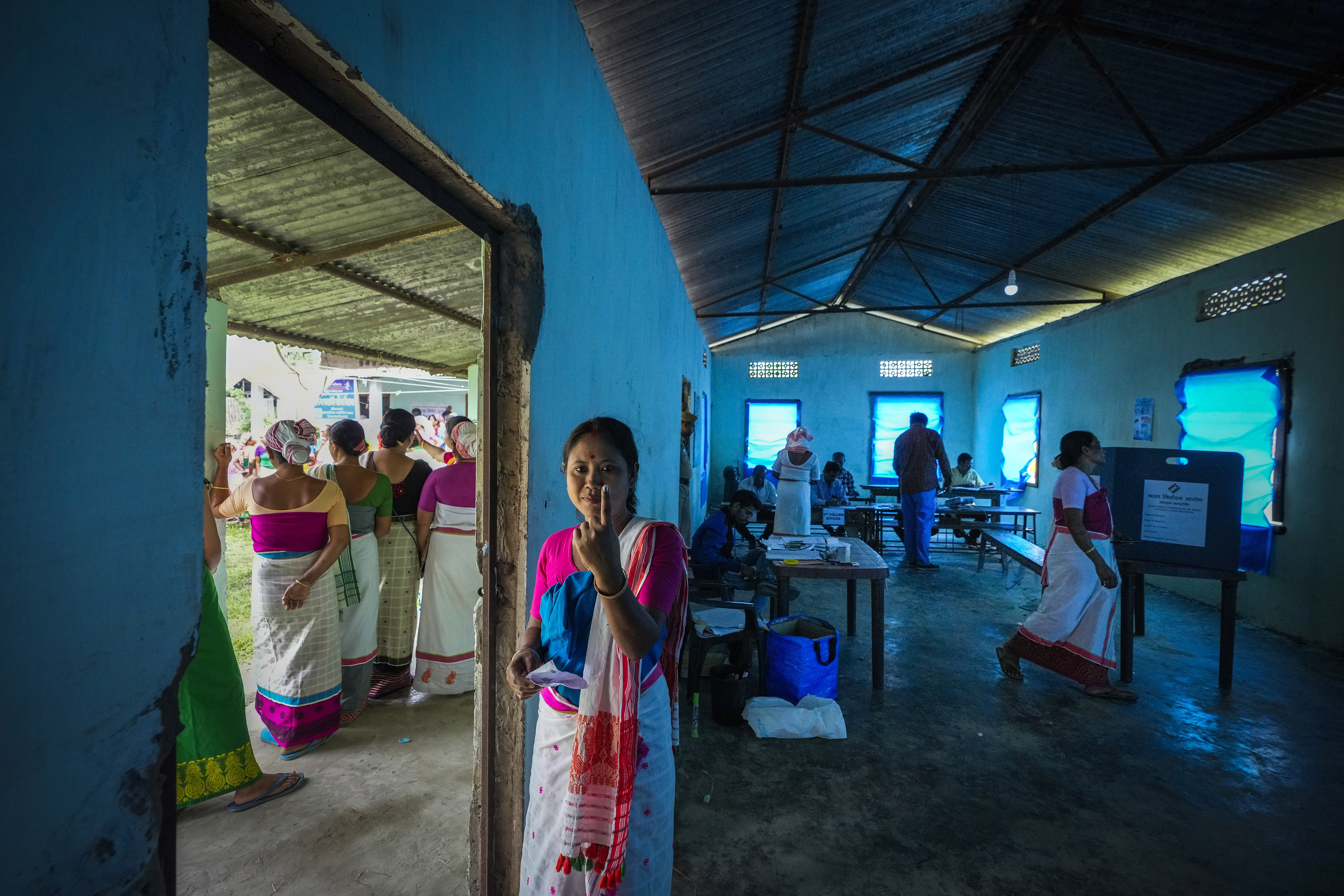 A Deori tribal woman shows the indelible ink mark on her finger after casting her vote during the first round of polling of India's national election in Jorhat, India, Friday, April 19, 2024. Nearly 970 million voters will elect 543 members for the lower house of Parliament for five years, during staggered elections that will run until June 1. (AP Photo/Anupam Nath)
