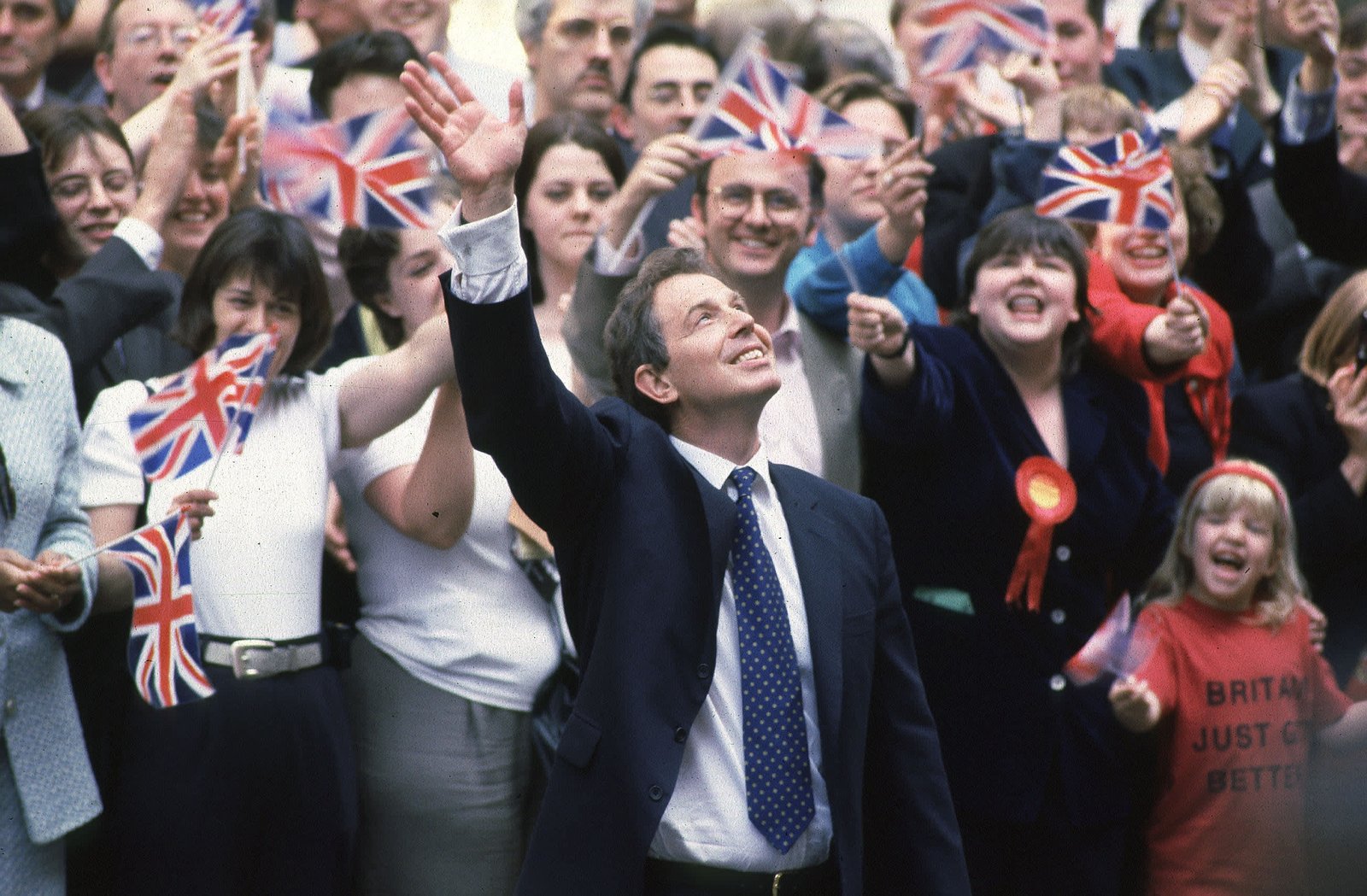 Labour leader Tony Blair arriving in Downing Street after his election victory with crowds waving flags in the background, 2nd May 1997.