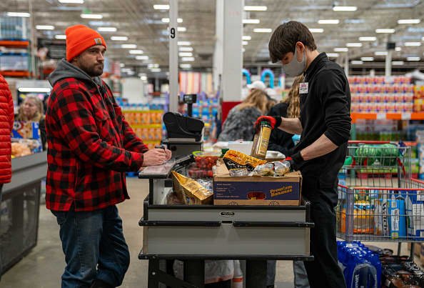 A customer moves through the check out lane with his groceries at a Costco Wholesale store on April 3, 2024 in Colchester, Vermont.