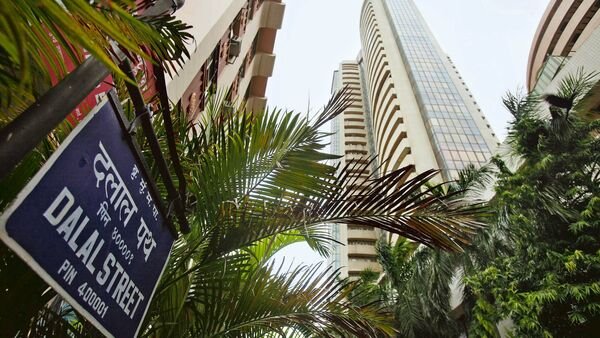 The Bombay Stock Exchange (BSE), right, stands on Dalal street in Mumbai, India, on Tuesday, June 18, 2013. Indian stocks declined as the rupee weakened the most in a week before the U.S. Federal Open Market Committee begins a two-day meeting today. Photographer: Adeel Halim/Bloomberg