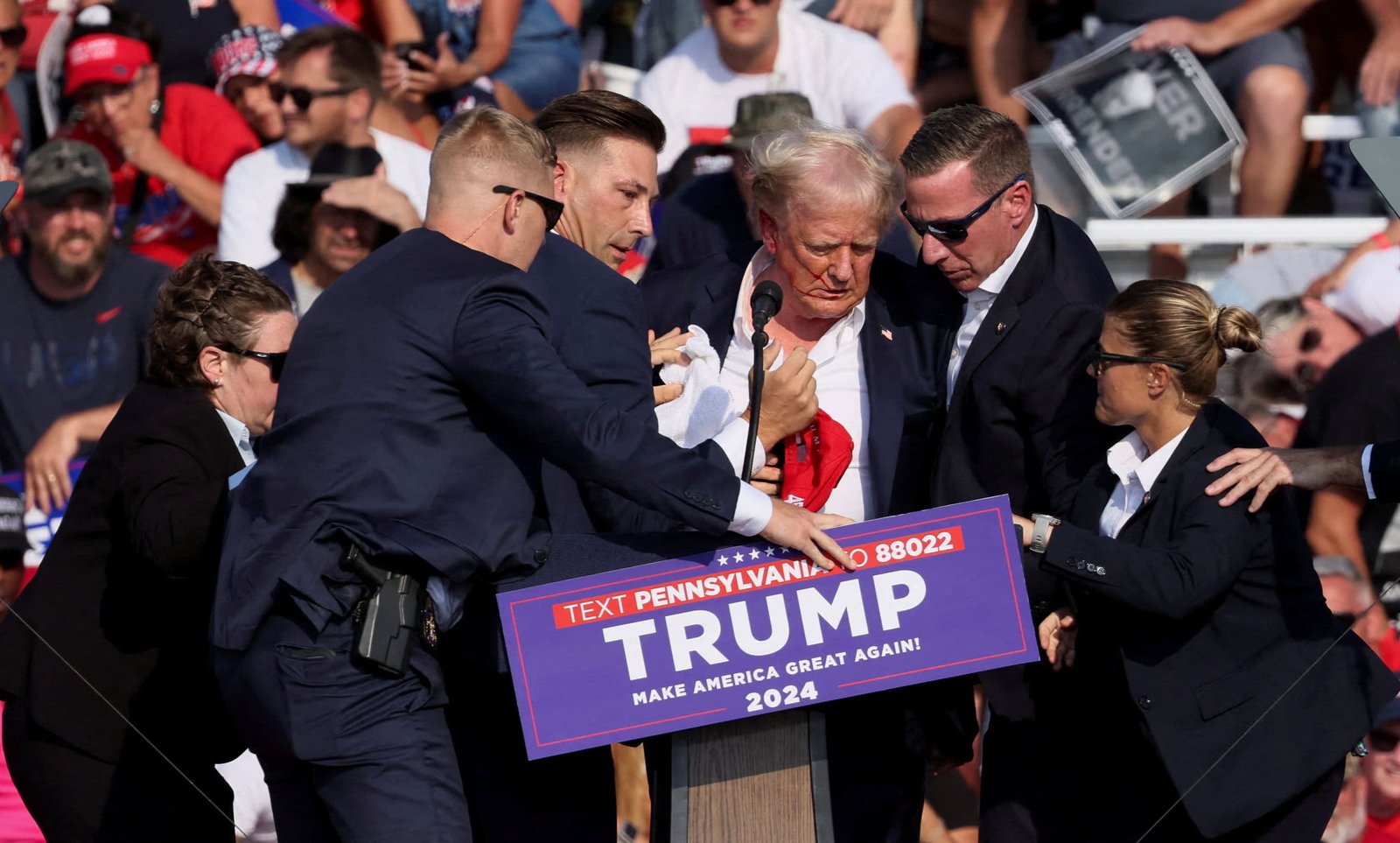 Republican presidential candidate and former U.S. President Donald Trump is assisted by U.S. Secret Service personnel after gunfire rang out during a campaign rally at the Butler Farm Show in Butler, Pennsylvania, U.S., July 13, 2024.