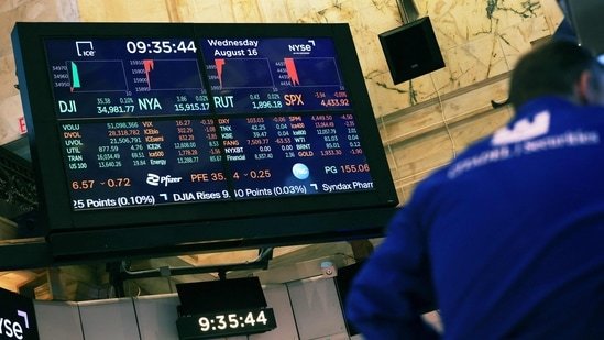 Stock market numbers are displayed on a screen at the New York Stock Exchange in New York City (Michael M. Santiago / Getty Images via AFP)