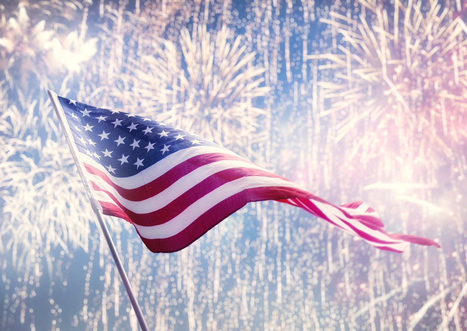 American flag on background of fireworks.