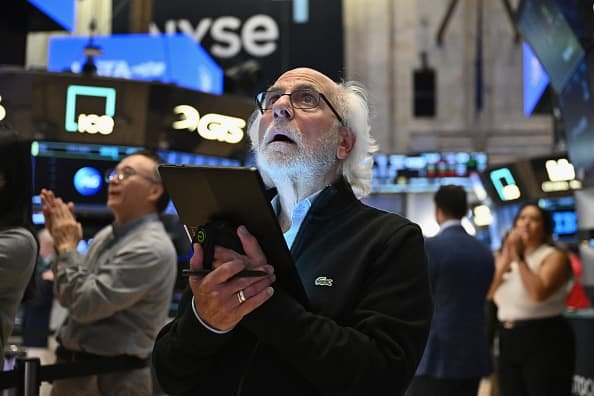 Traders work on the floor of the New York Stock Exchange during morning trading on Aug. 23, 2024.