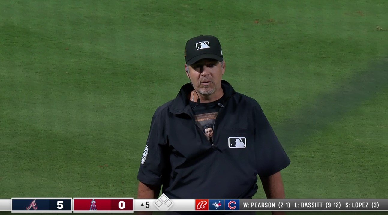 As umpire James Hoye was announcing the results of a review, Angels announcer Wayne Randazzo noticed Hoye wearing a Kramer undershirt. Photo Credit: Bally Sports West