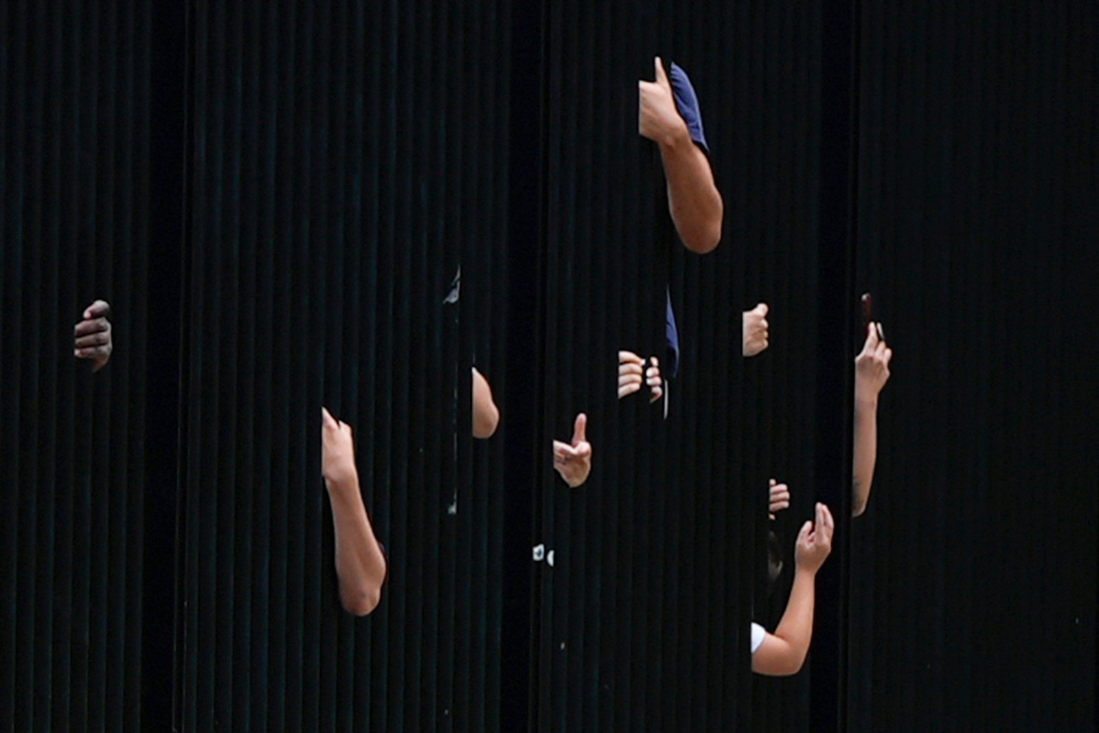 Visitors reach through the White House fence, Tuesday, July 23, 2024, in Washington. (AP Photo/Julia Nikhinson)