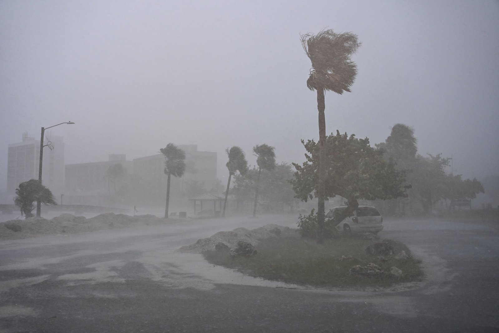 A car is seen parked as it rains heavily in Fort Myers, Florida, on October 9, 2024 as Hurricane Milton approaches. 