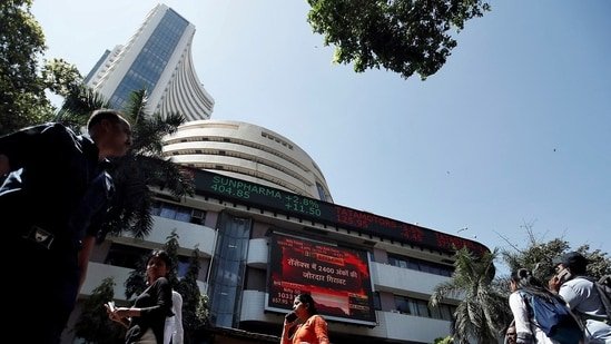 People walk past the Bombay Stock Exchange (BSE) building in Mumbai, India, March 9, 2020.