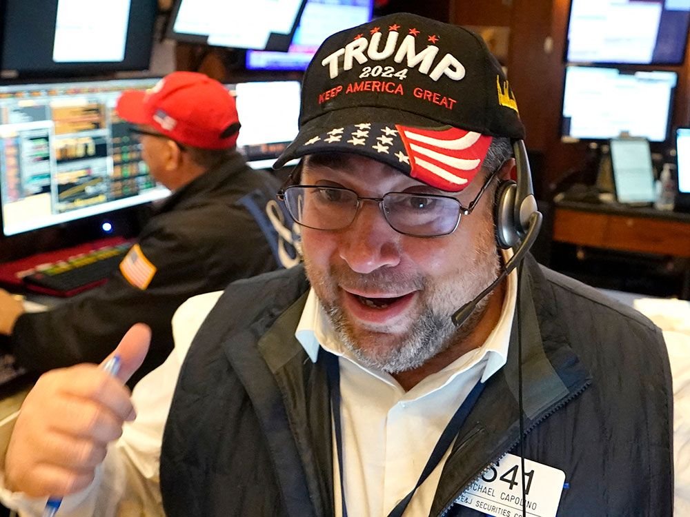 A trader wears a Trump hat while working on the floor at the New York Stock Exchange. Stocks have surged since his victory in the election.