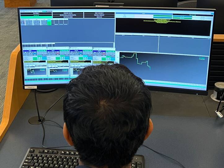 A student uses a computer that has multiple charts displayed.