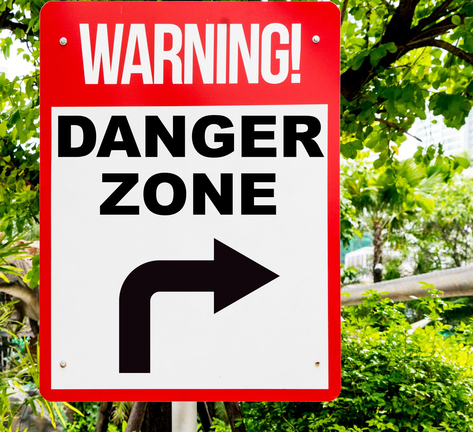 Warning Danger Zone red signage in forest.