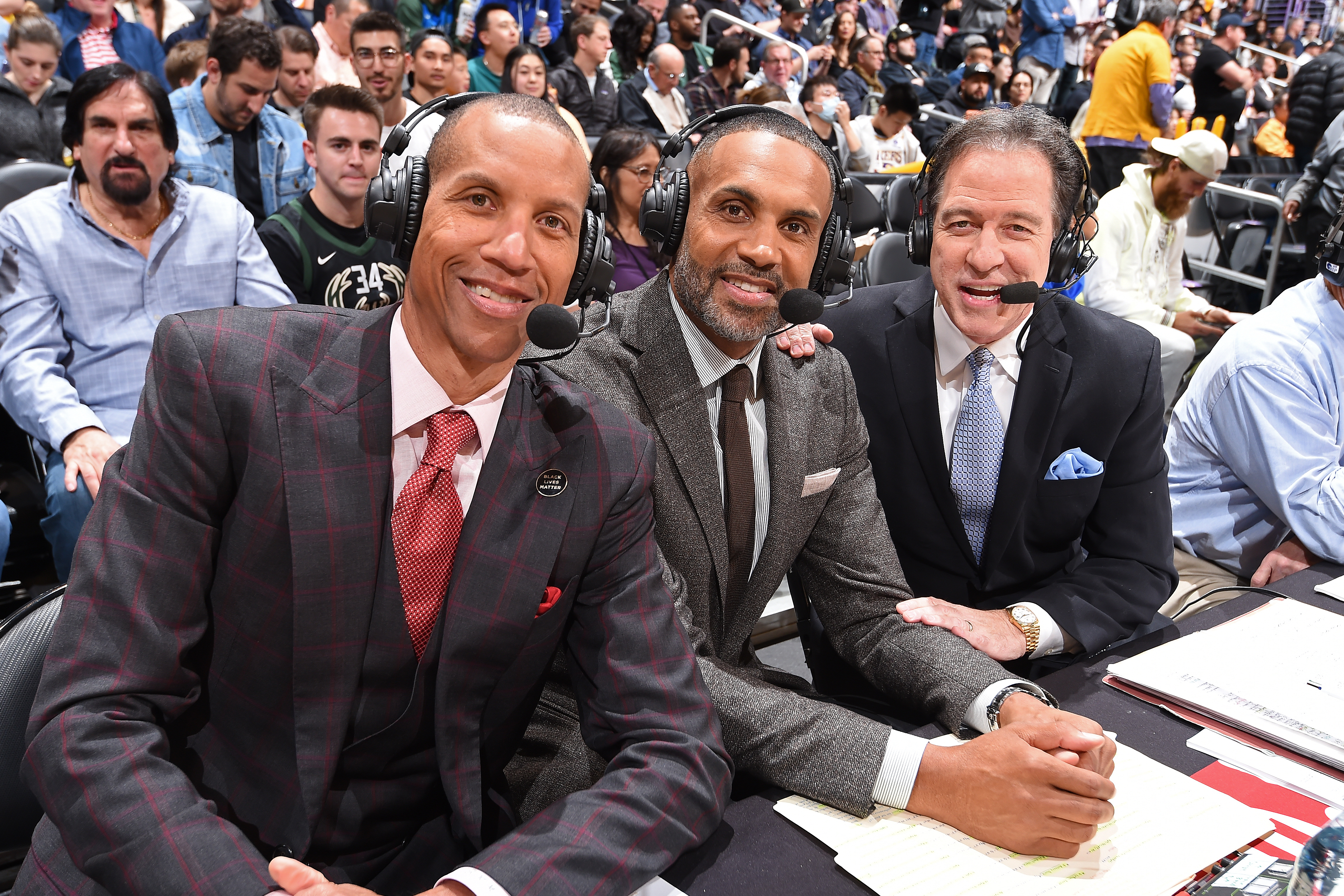 Reggie Miller, Kevin Harlan, and Grant Hill at an NBA game.