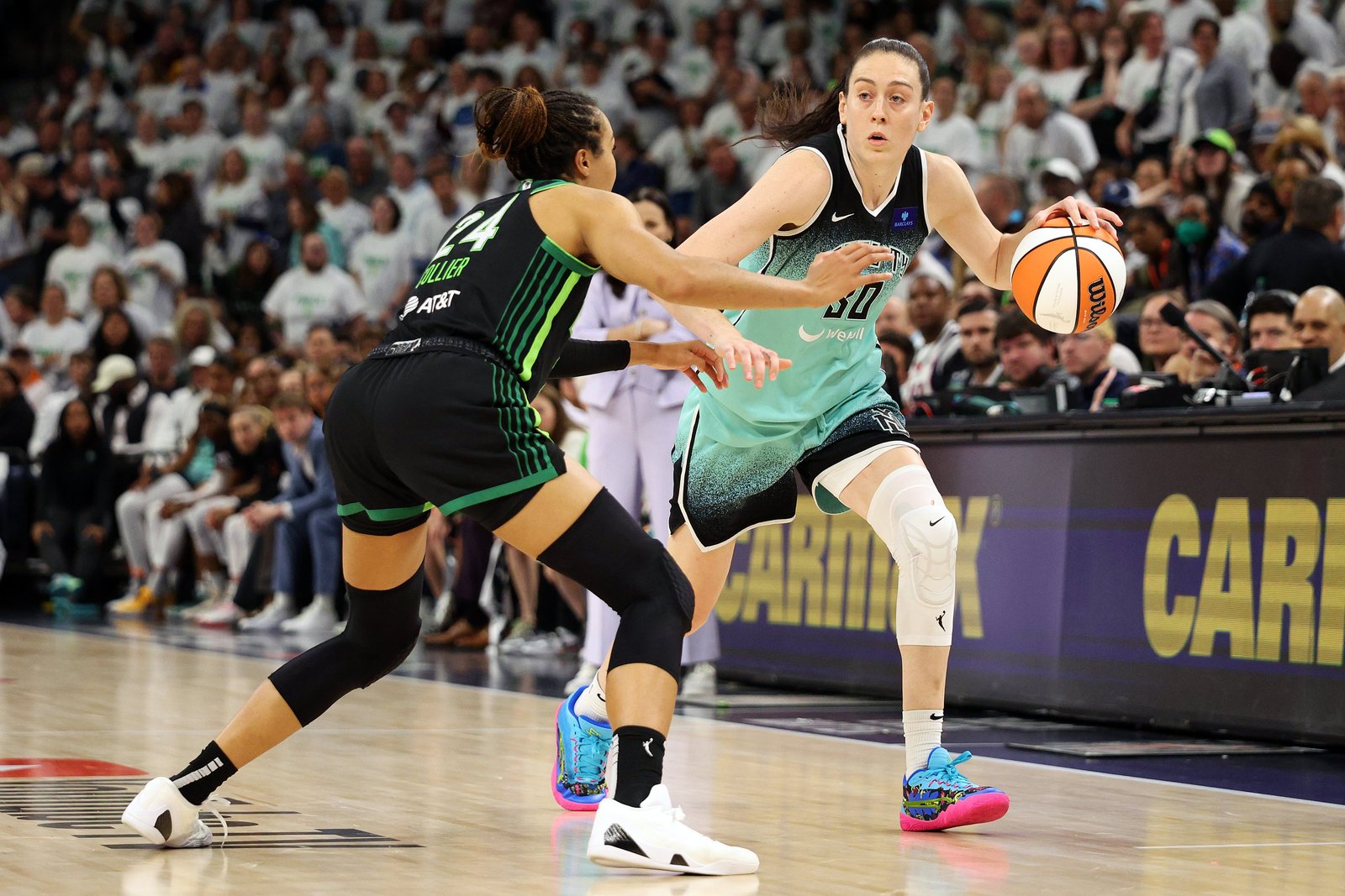 Breanna Stewart #30 of the New York Liberty dribbles the ball against Napheesa Collier #24 of the Minnesota Lynx in the fourth quarter during Game Three of the WNBA Finals at Target Center on October 16, 2024 in Minneapolis, Minnesota. 