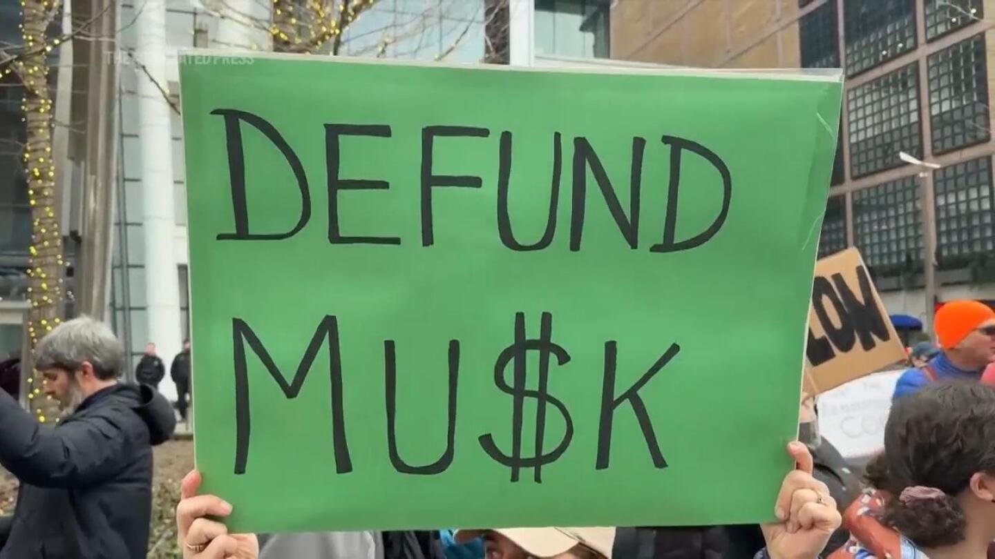 demonstrators-gather-outside-a-tesla-showroom-in-boston-to-protest-against-trump-and-musk