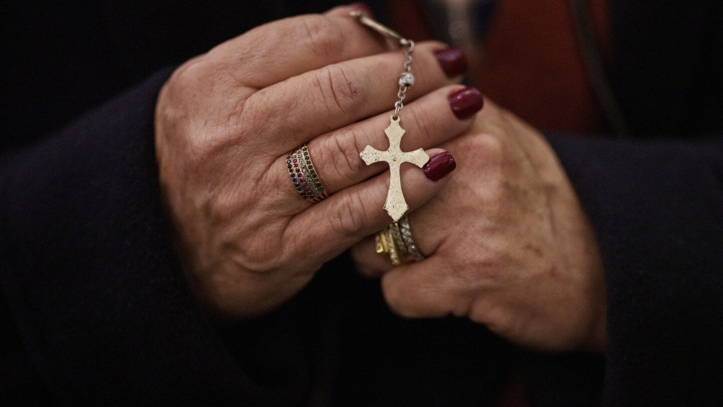 clutched-by-the-global-faithful-and-draped-on-candles-and-statues,-rosaries-abound-for-pope-francis