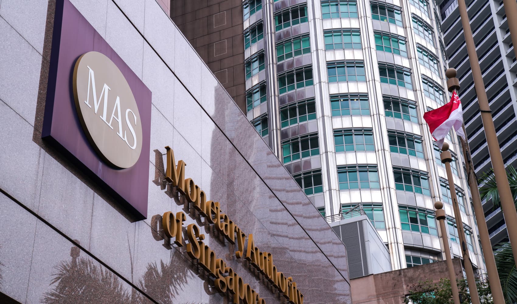 Signage for the Monetary Authority of Singapore is displayed outside the central bank’s headquarters in Singapore, on October 22, 2019. Singapore’s central bank tightened its monetary policy on Thursday, saying the widely forecast move will slow the inflation momentum.