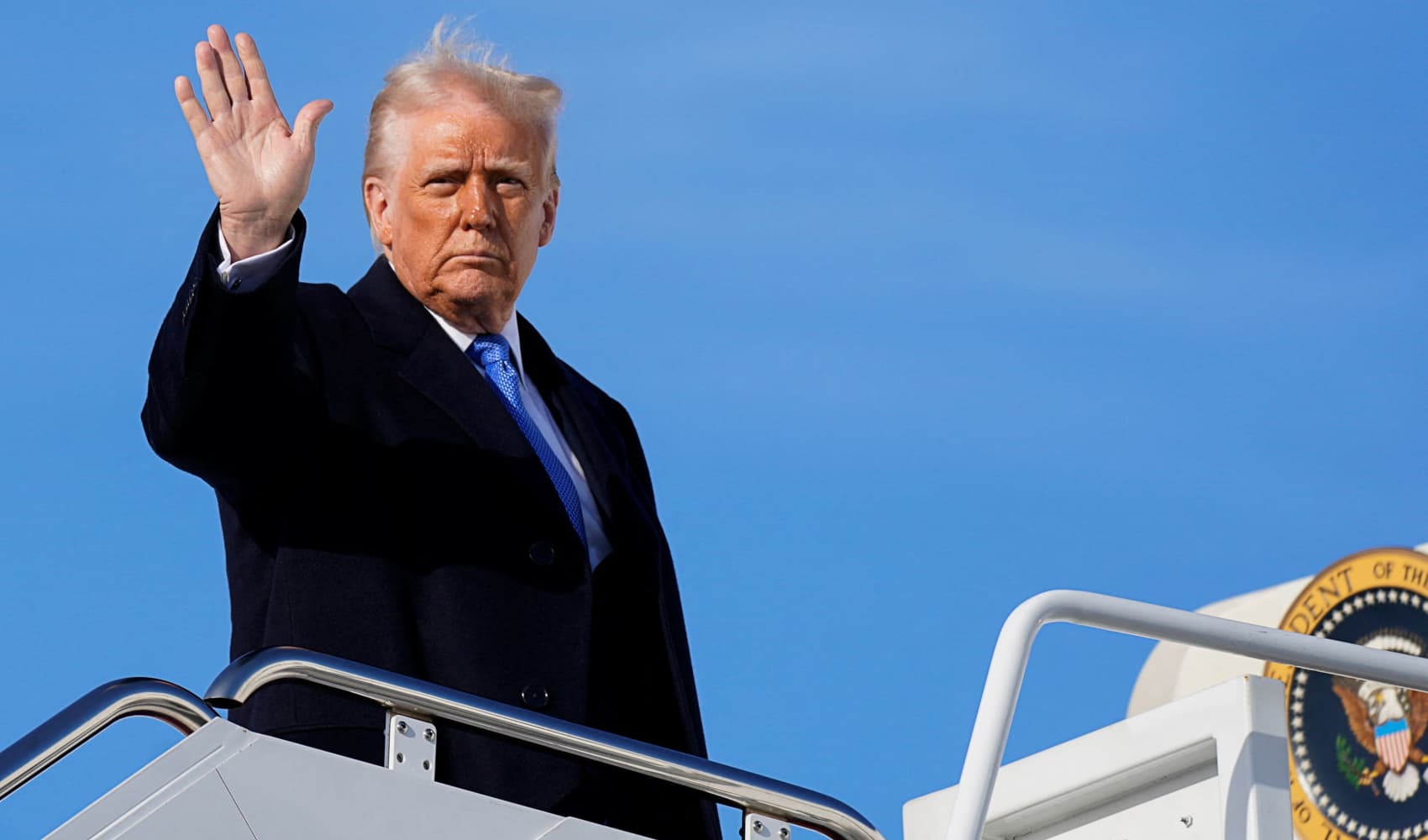 U.S. President Donald Trump gestures, as he boards Air Force One to depart for New Jersey at Joint Base Andrews, Maryland, U.S., March 21, 2025. 