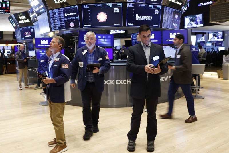 Traders work on the floor of the New York Stock Exchange on Wall Street on Monday. Stocks indexes ended the week lower. Photo by John Angelillo/UPI