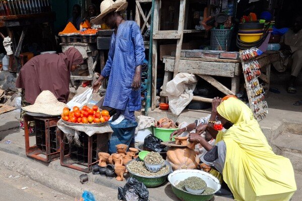 A man sells tomatoes at the main market in Maiduguri, Nigeria, Saturday, March 15, 2025. (AP Photo/Joshua Olatunji)