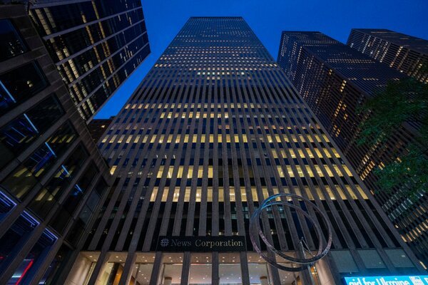 An exterior photo of the News Corp headquarters building in Manhattan, looking up from the ground. 