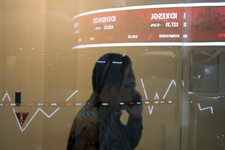 Declining share prices are reflected in a window at the Indonesia Stock Exchange in Jakarta on Tuesday, April 8, 2025.