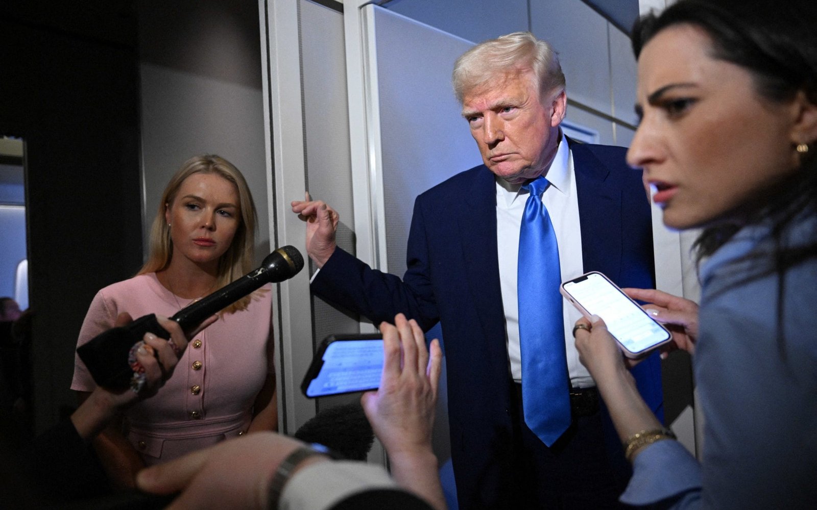 Donald Trump speaks to reporters on board Air Force One