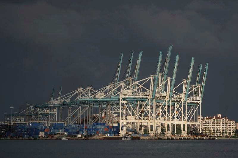 Cranes and shipping containers are seen at PortMiami on April 8, 2025, in Miami.
