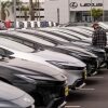 A person looks at a new vehicle at a Toyota dealership in El Monte, Calif., on Thursday, the day the 25% car import tariff went into effect in the U.S.
