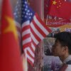 A man walks into a store displaying Chinese and U.S. flags in Beijing.