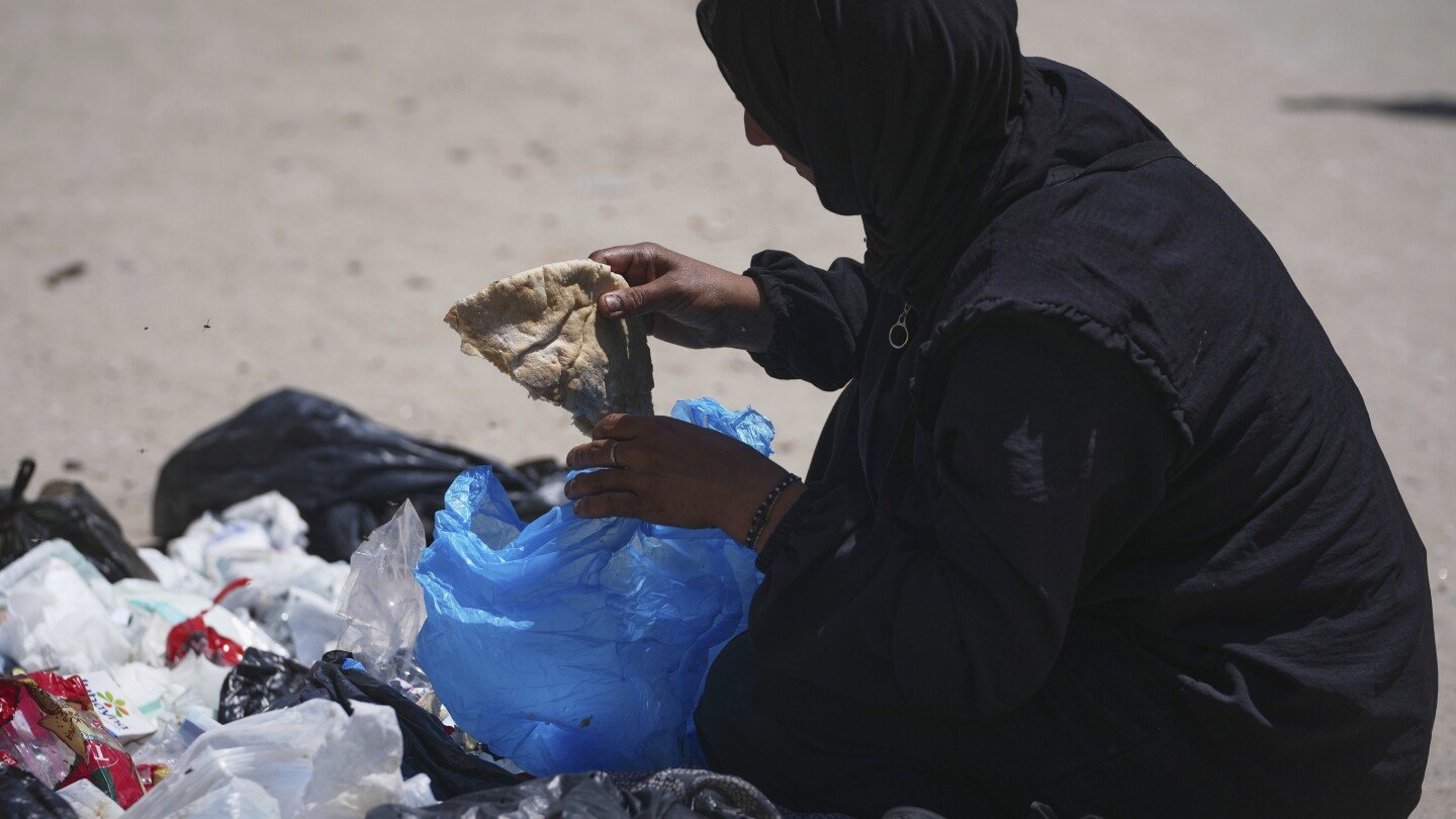 a-family-digs-through-trash-for-bits-of-food,-showing-gaza’s-growing-desperation