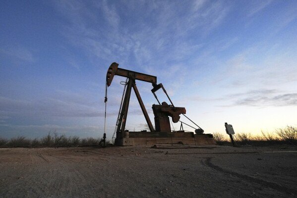 A pumpjack is visible before sunrise Wednesday, Feb. 26, 2025, in Kermit, Texas. (AP Photo/Julio Cortez)