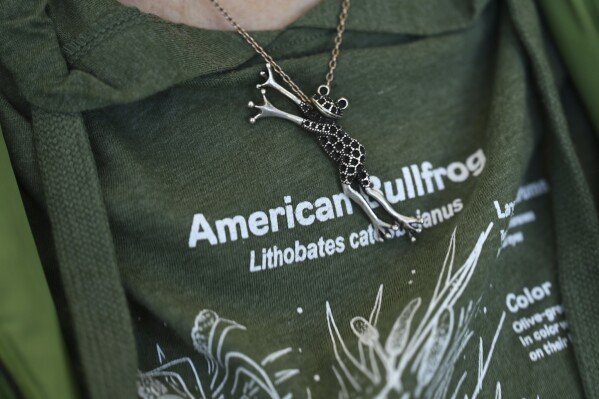 Margot Fass wears a frog pendant Friday, March 21, 2025, in Pittsford, N.Y. (AP Photo/Maryel Pryce)