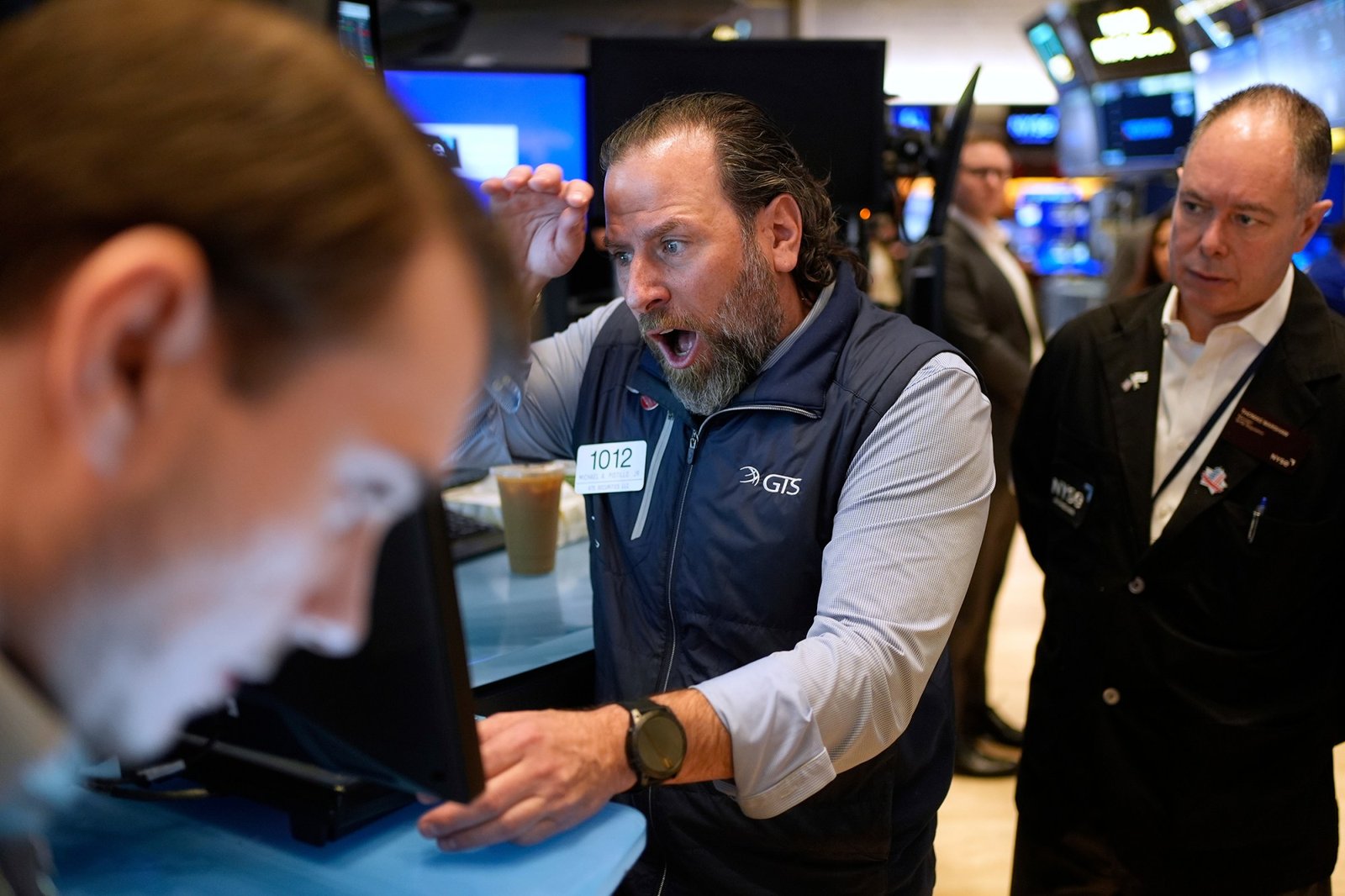 Mike Pistillo Jr., center, works with other traders on the floor at the New York Stock Exchange in New York, Thursday, April 3, 2025. (AP Photo/Seth Wenig)