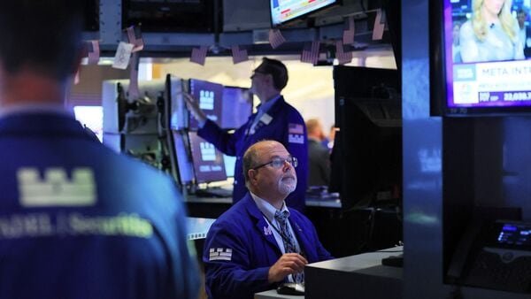 Traders work on the floor of the New York Stock Exchange. The S&P 500’s solid spring rally already has stalled, with the benchmark now just 0.3% higher over the past month, and the average Wall Street forecast calls for only a modest advance by the end of the year. (Getty Images via AFP)