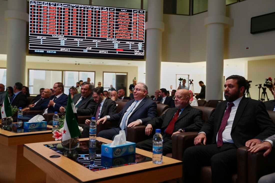 Syrian Finance Minister Mohammed Yisr Barnieh, center, attends the opening ceremony at the Damascus Securities Exchange in Damascus, Syria, Monday, June 2, 2025. (AP Photo/Omar Sanadiki)