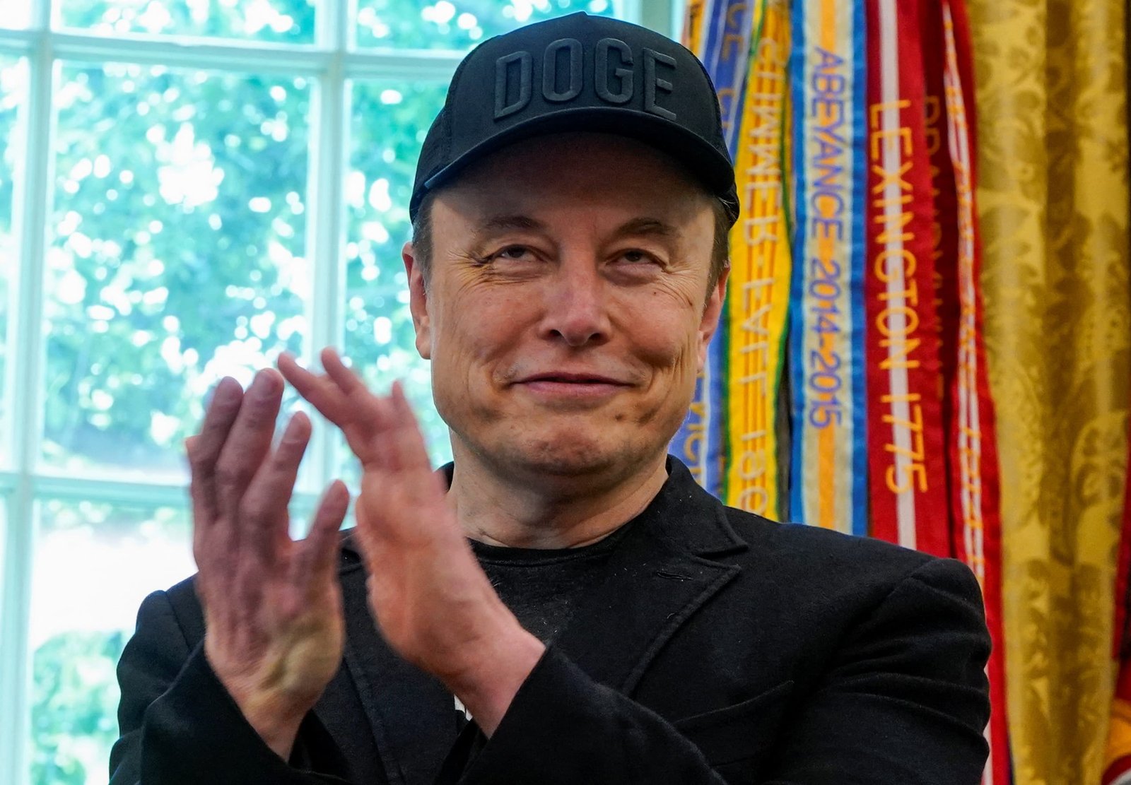 Elon Musk applaudes in the Oval Office as he attends a press event with U.S. President Donald Trump, at the White House in Washington, D.C., U.S., May 30, 2025.