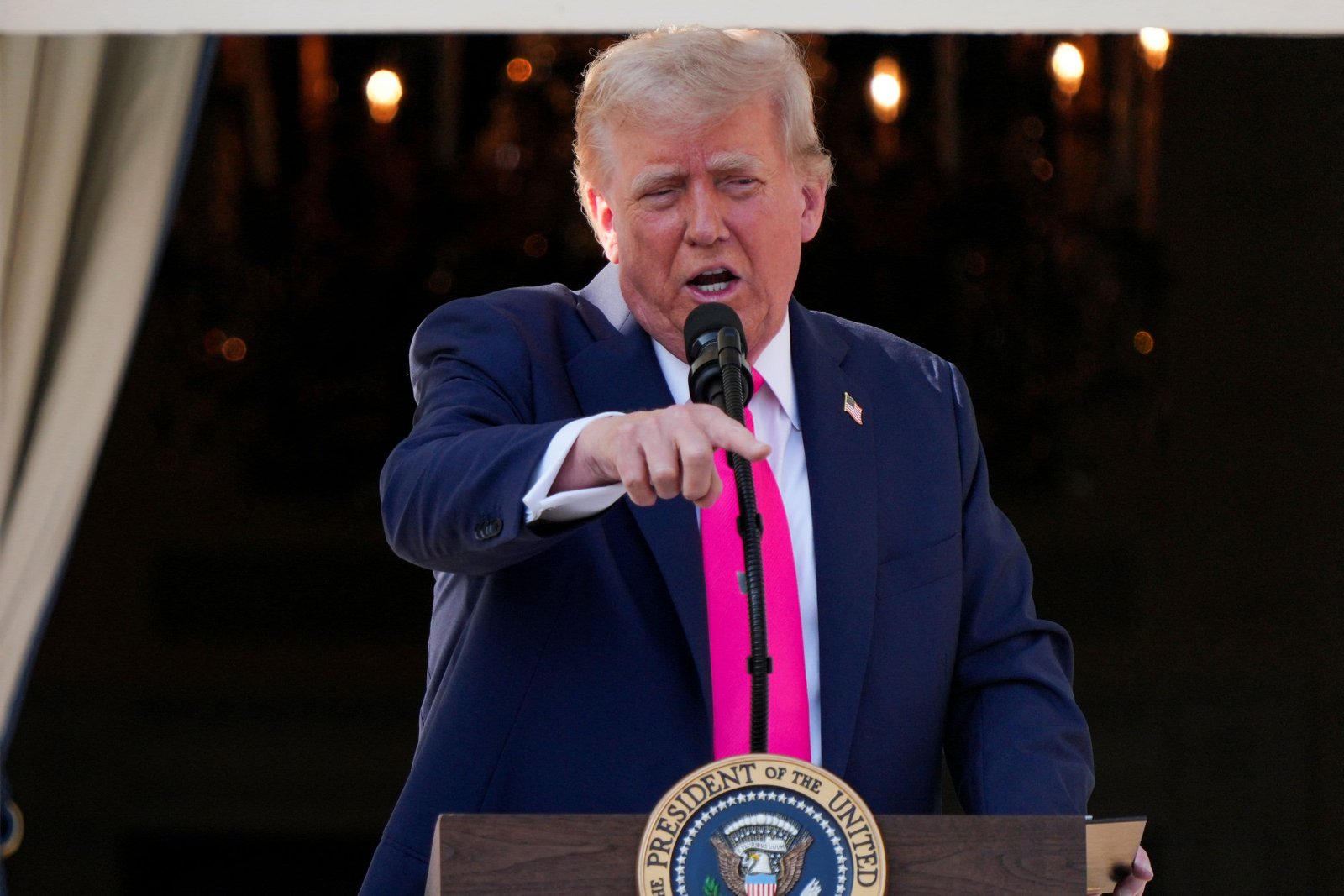 U.S. President Donald Trump gestures, as he speaks from a balcony, on the day he is expected to sign a sweeping spending and tax legislation, known as the