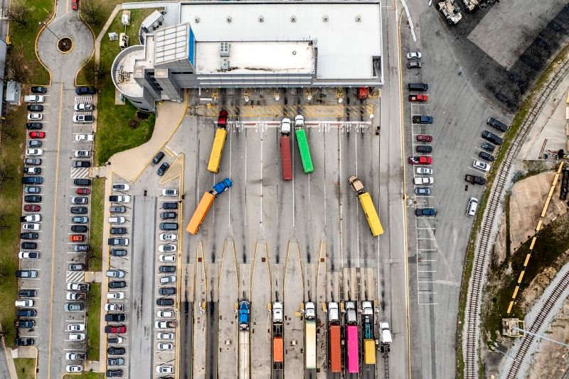 This aerial view shows semi-trailer trucks carrying shipping containers waiting to enter the Port of Baltimore on April 10 in Maryland.