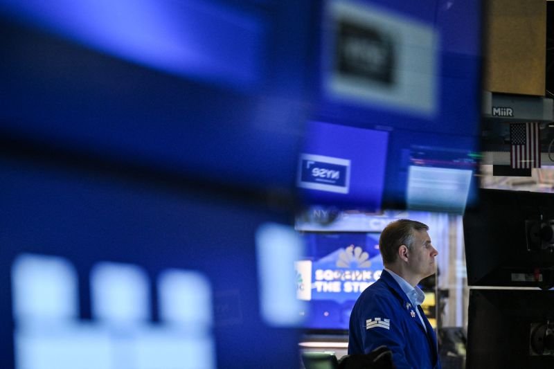 A trader works on the floor of the New York Stock Exchange (NYSE) at the opening bell on July 15, 2025.