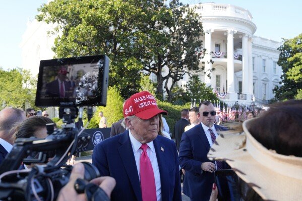 President Donald Trump greets active-duty military service members and their families during a Fourth of July celebration on the South Lawn of the White House in Washington, Friday, July 4, 2025. (AP Photo/Alex Brandon, Pool)