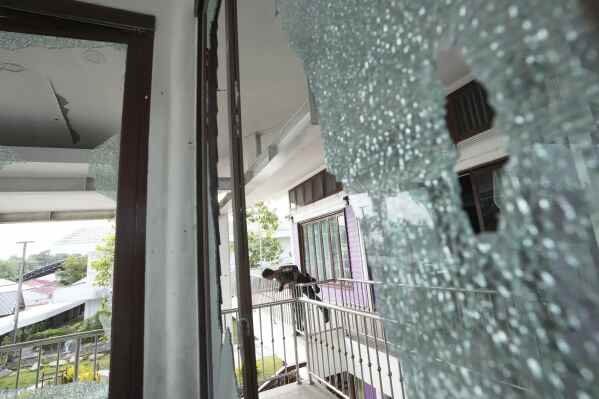 A Thai soldier stands at the Phanom Dong Rak hospital damaged after Cambodia fired artillery shells in Surin Province, Thailand, Friday, July 25, 2025. (AP Photo/Sakchai Lalit)