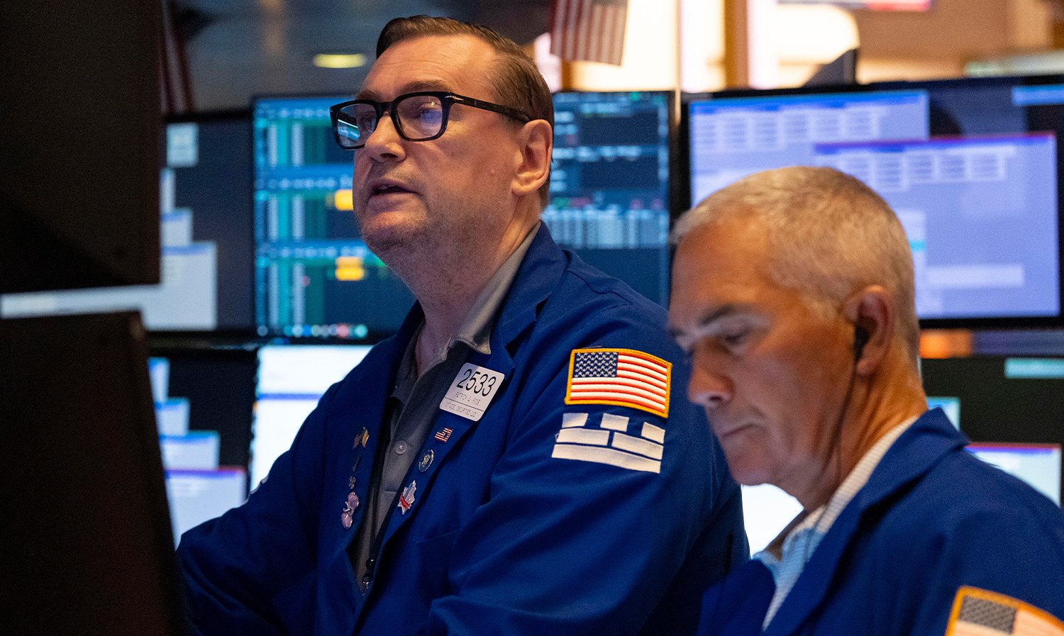Traders work on the floor of the New York Stock Exchange, Friday, Aug. 1, 2025, in New York.