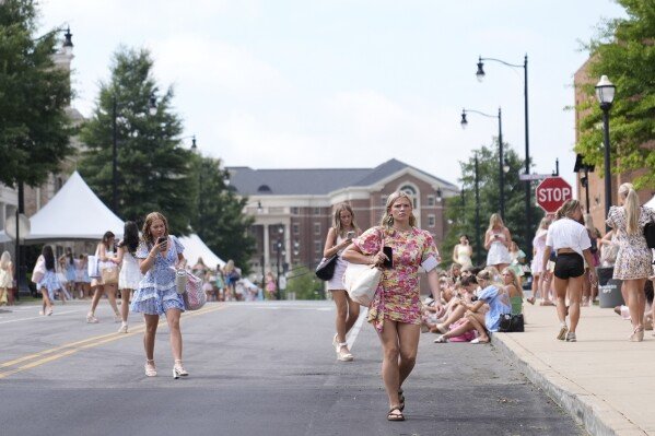 Sorority recruits walk near sorority row at the University of Alabama, Thursday, Aug. 14, 2025 in Tuscaloosa, Ala. (AP Photo/Brynn Anderson)