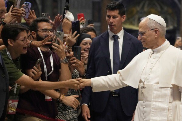 Pope Leo XIV greets faithful at the end of a mass celebrated by Cardinal Luis Antonio Tagle in St. Peter's Basilica on the occasion of the Youth Jubilee at the Vatican, July 29, 2025. (AP Photo/Gregorio Borgia, File)