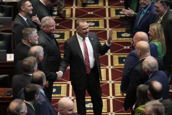Missouri Gov. Mike Kehoe greets lawmakers as he enters the house chamber to deliver the State of the State address, Jan. 28, 2025, in Jefferson City, Mo. (AP Photo/Jeff Roberson, File)
