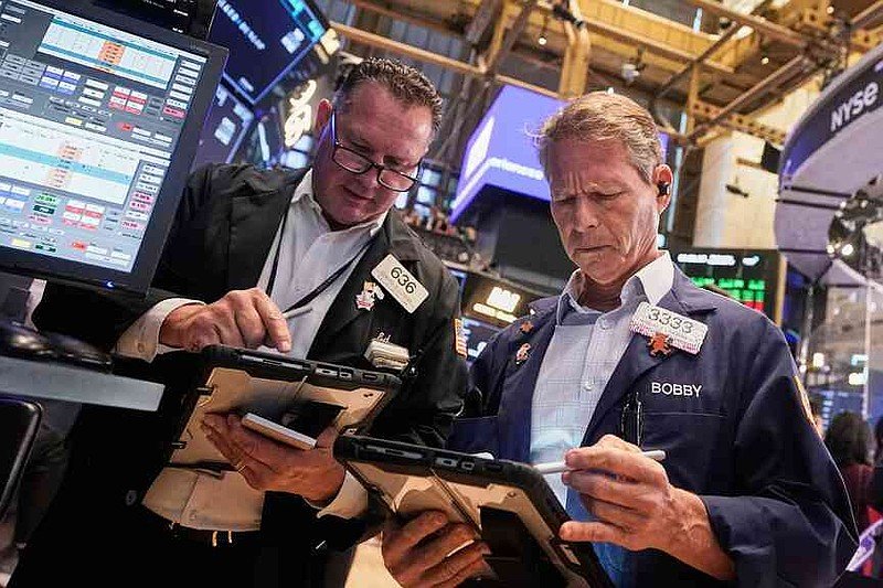 Traders Edward Curran, left, and Robert Charmak work on the floor of the New York Stock Exchange, Wednesday, Sept. 17, 2025. (AP Photo/Richard Drew)