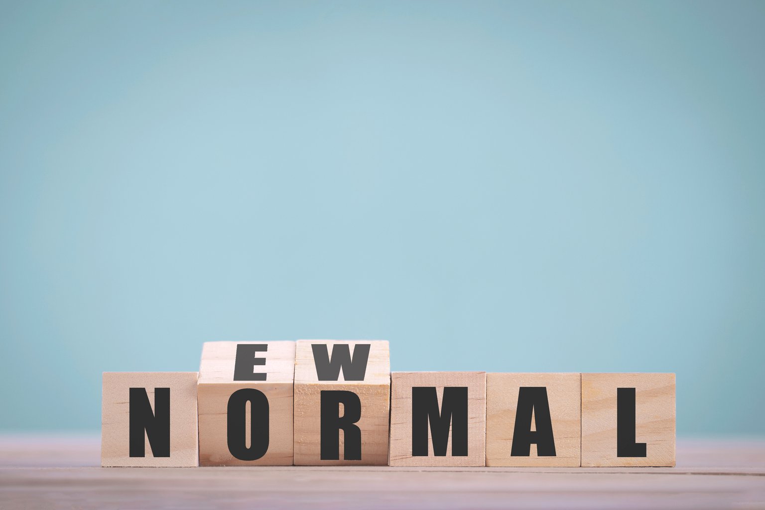 Wooden block cubes flipping for new normal word to changing new lifestyle or business and economy after coronavirus pandemic